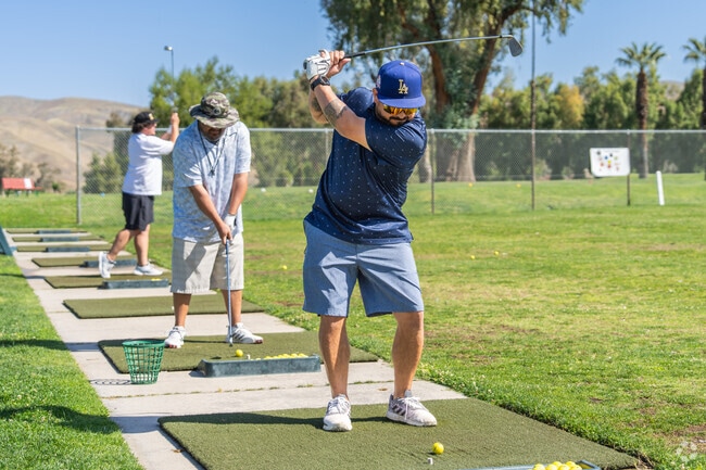 A Tuscany golfer perfects his swing at the nearby Kern River Golf Course.