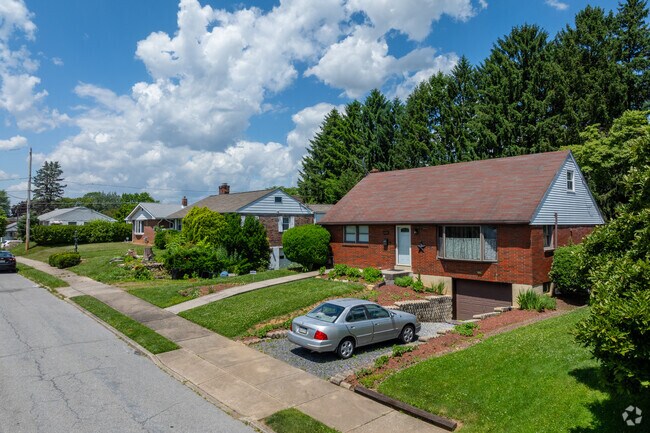 Cape cods have big yards and lower level garages leading to basements in Highland Park.