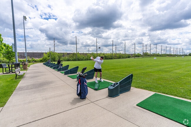 Locals swing at the driving range before a game at the Beverly Country Club in Evergreen Park.