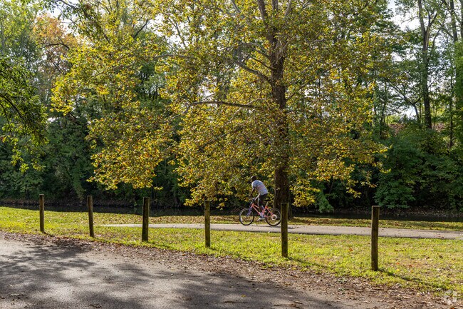 A bicyclist rides past on the trail at the West Side Park in Muncie, IN.