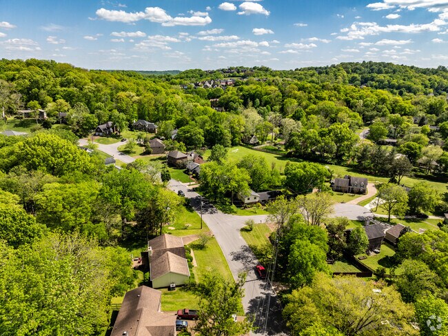 Rolling River is surrounded by hills and trees.