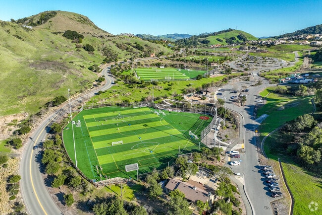 Sports venue featuring multiple grass and turf soccer fields on a hillside at Wilder Fields and Park.
