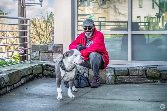 A Newport resident sits with his dog outside a local Starbucks.