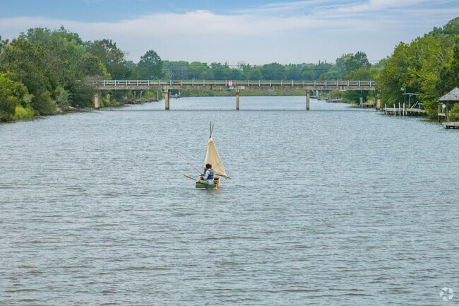 Friends sail a small craft on the Diversionary Canal, which runs through Hitchcock.