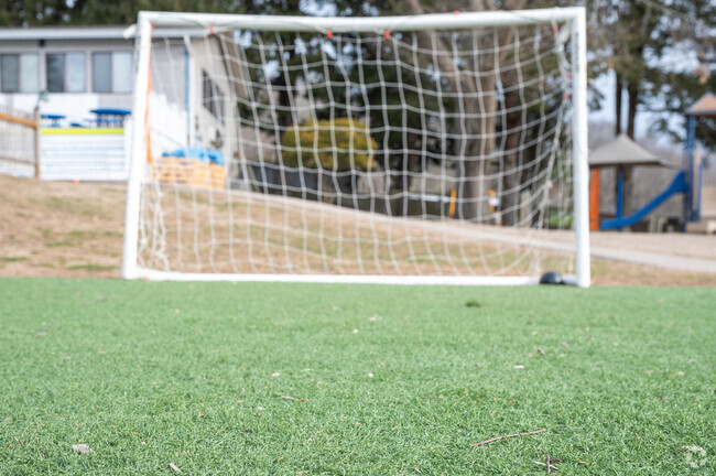 Students at Inly School in Scituate enjoy a game of soccer on the turf field during recess.