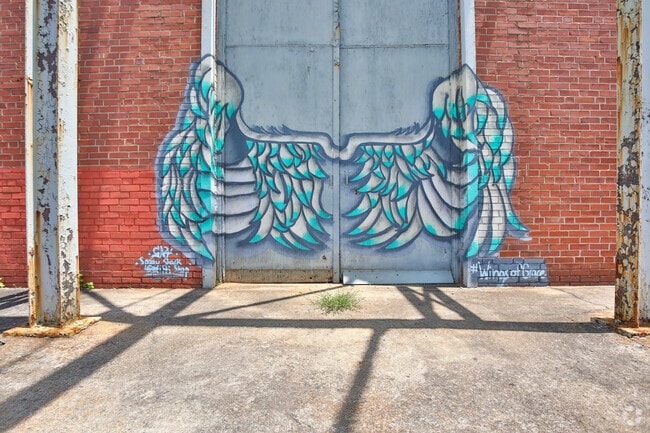 Local artists decorate West End walls with painted wings.