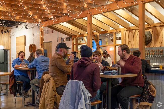 Friends gather inside Half Acre Brewery for dinner and drinks in Chicagos Bowmanville area.
