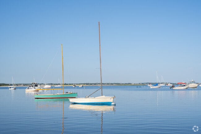 Sailboats gently blow sway in the wind of a bay in Osterville.