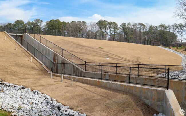 Gresham Park's Glen Emerald Park Lake features a small dam along the walking trail.