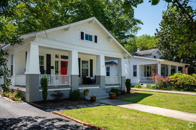 A row of bungalow homes with very large front porches.