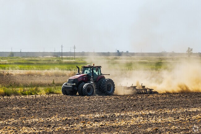 A tractor is preparing the farmland around Biggs for future crops.