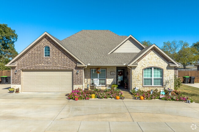Newly built traditional-style homes have exteriors with a mix of brick and stone.