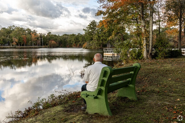 Sit on a bench at Reflections Park in Pemberton Township and enjoy the lake views of Mirror Lake.