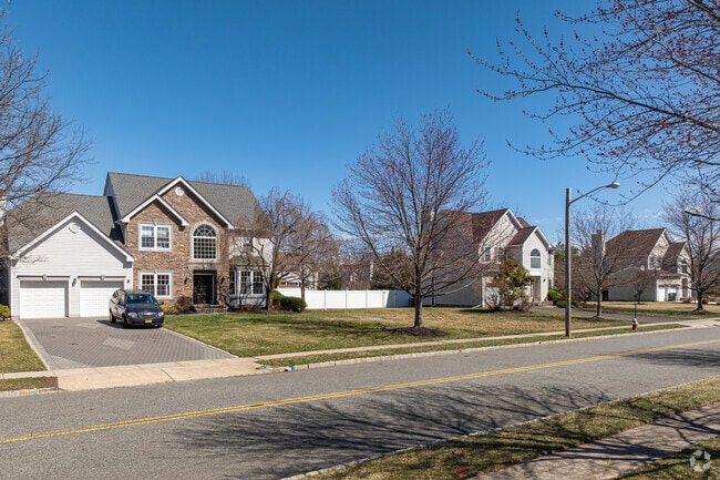 Properties in the area typically include driveways and garages.