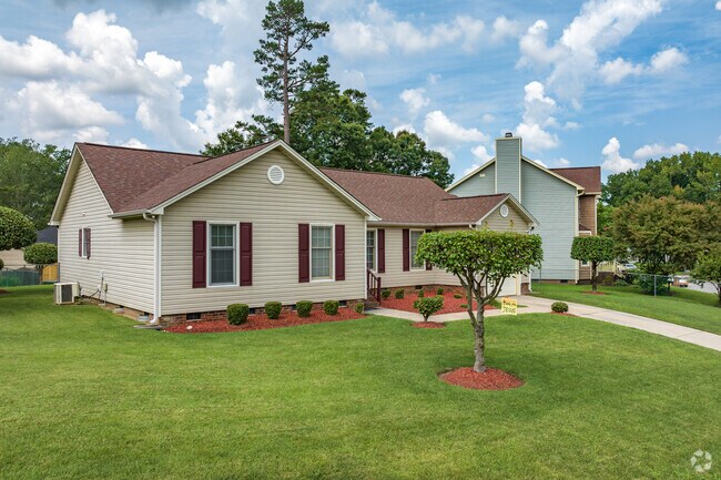 A single-story home in Rolling Roads features a well-manicured lawn.