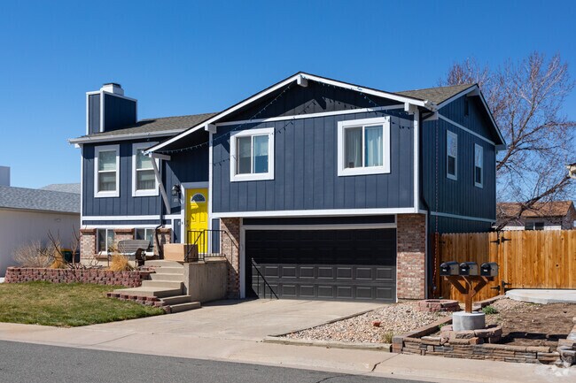 Split-level house with brick accents includes an attached garage in Friendly Hills.