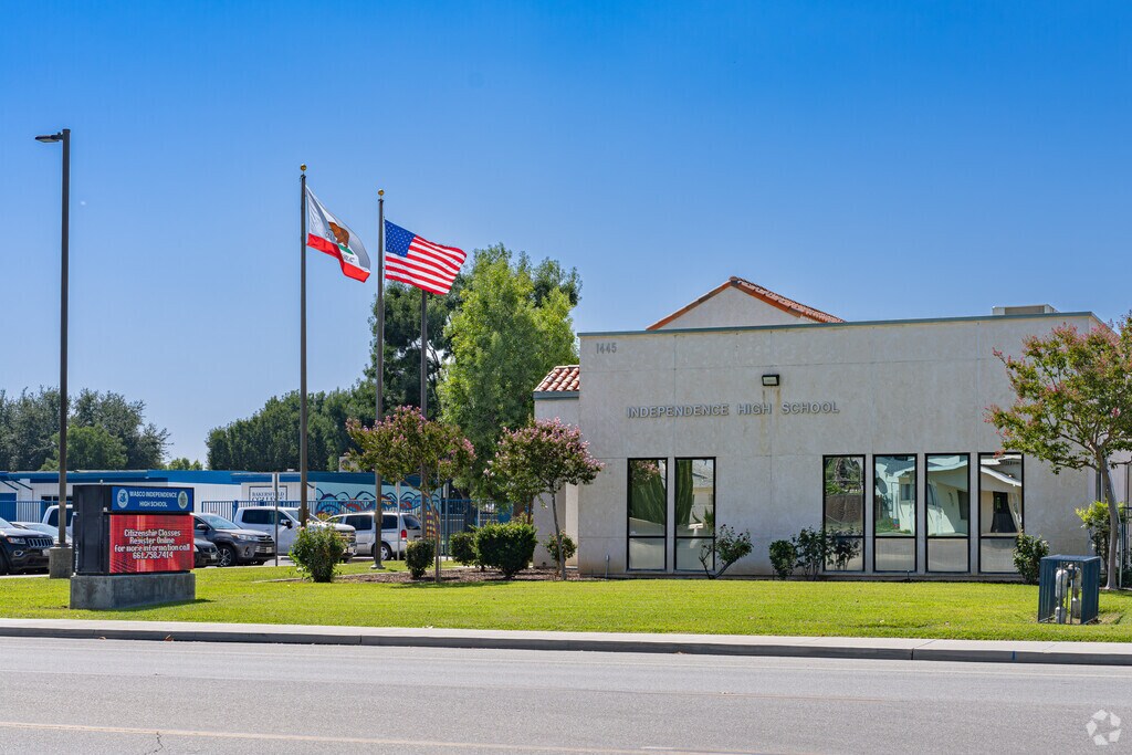 An American flag waves at the entrance to Independence High School in Wasco.