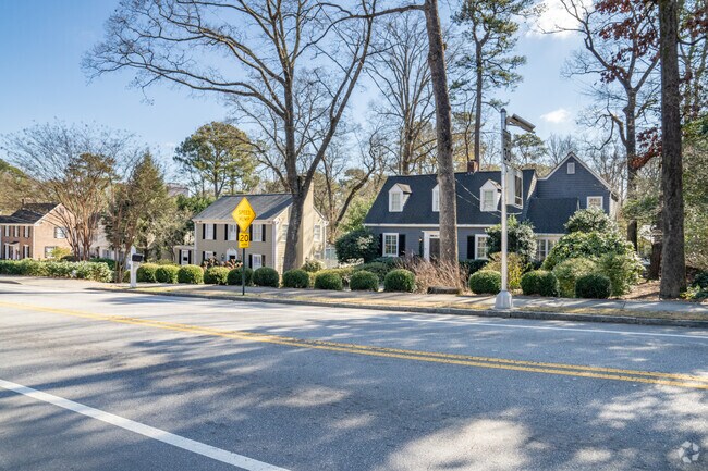 Homes in a variety of architectural styles are shaded by tall trees in Collier Hills.