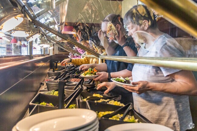 Locals enjoy the all-you-can-eat salad bar at Ruby Tuesday's in Presque Isle, finding it a welcome option for a light and healthy meal, amidst the hearty fare that characterizes many Maine dining experiences.