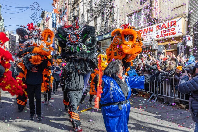Chinatown residents celebrate Chinese New Year with colorful costumes, music, & firecrackers.