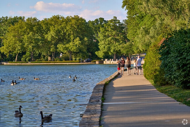 A family walks together on the trail around the lake in Hagerstown City Park.