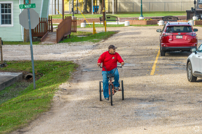 A man rides a tricycle to town in Scott, Louisiana.