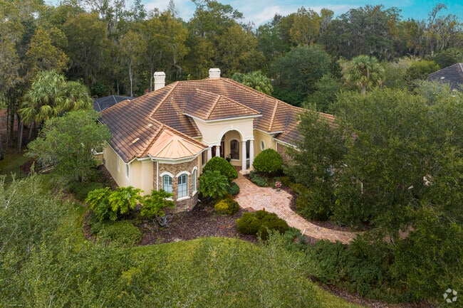 This Spanish-style home in Fellowship has ample privacy with its mature trees.