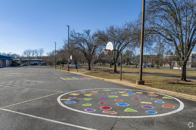 Outdoor athletic and black top entertainment area for students at Mckee Road Elementary School.
