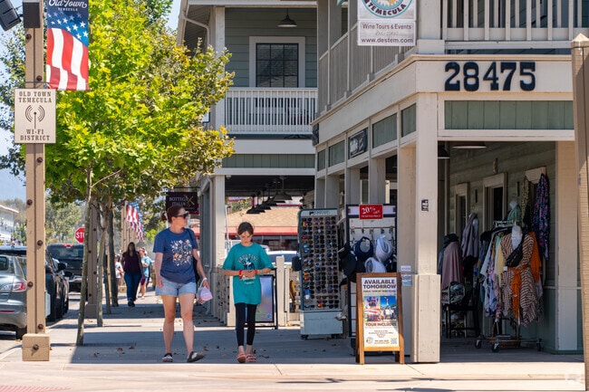 Pedestrian-friendly shopping district in Old Town Temecula with outdoor displays and vintage architecture.