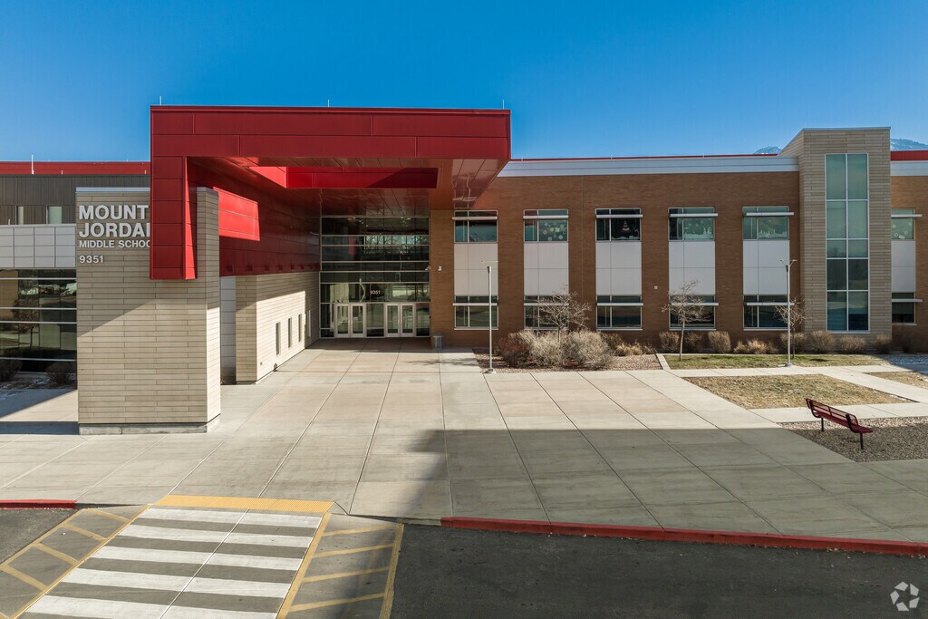 Mount Jordan Middle School’s entrance is marked by a modern, red architectural feature.
