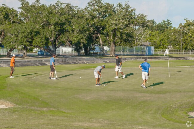 A group of golfers plays a round at Frasch Golf Course near Carlyss.