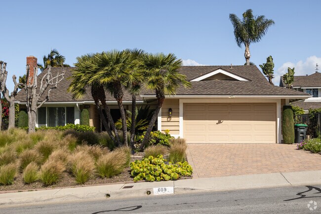 Craftsman, Mediterranean and Victorian styles with lush lawns and palm trees make up the residential landscape of Coast District.