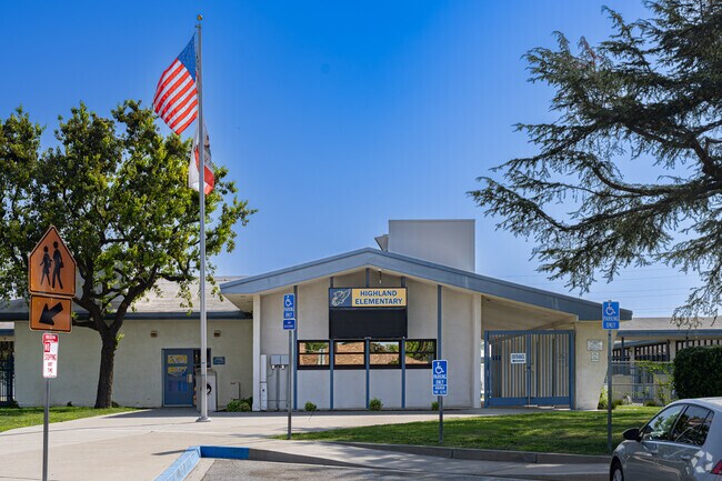 An American flag waves at the entrance to Highland Elementary School near Parkview Estates.