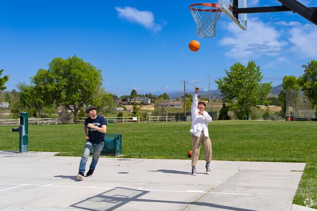 A father and son enjoy time together playing hoops at Meadowbrook Park.
