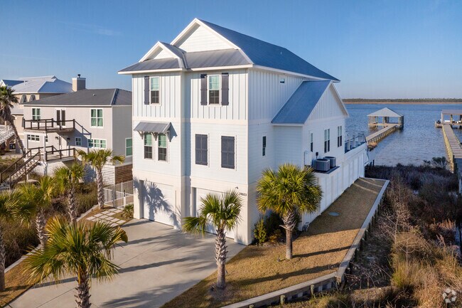 Grand waterfront homes are popping up along the shores of Wolf Bay in Elberta.