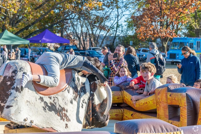 Kids have a great time riding a mechanical bull at the Sleepy Hollow Fall Festival.