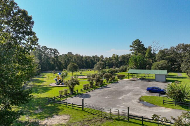 Families enjoy sunny days at Eugene Lamb Park with play areas and shaded tables.