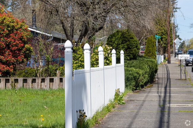 A bright white fence lines the residential streets of Powellhurst-Gilbert.