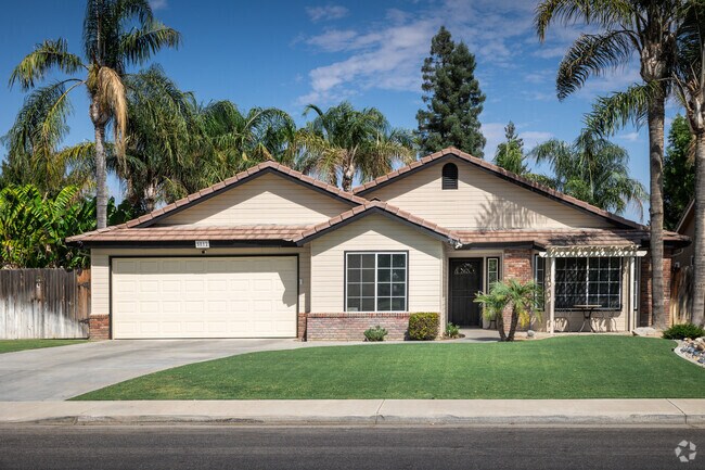 Home with wood panel siding and brick trim seen in The Seasons neighborhood in Bakersfield.