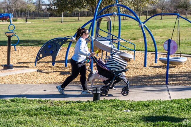 A woman walks with her child and dog on one of Dickinson's many walking trails.