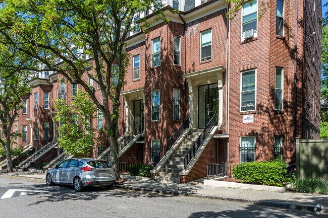 Homes in Fort Hill include brownstone townhomes with street parking.