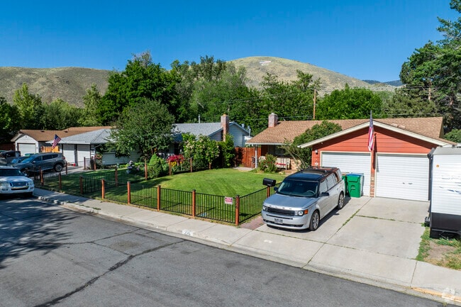Charming mid-century ranch homes in Carson City Center offer cozy curb appeal and lush green lawns beneath the hills.