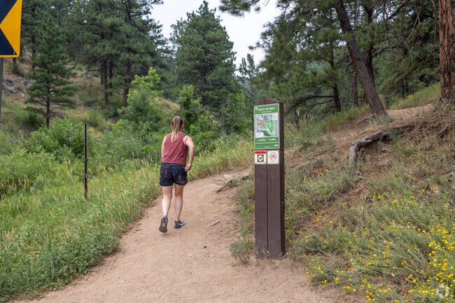 HikerA woman embarks on the Lions Lair trailhead in Seven Hills.