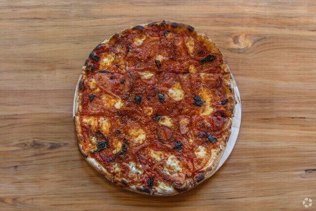 Locals love to visit Domenic's and Vinnie's for delicious pies, such as a classic Margherita Pizza.