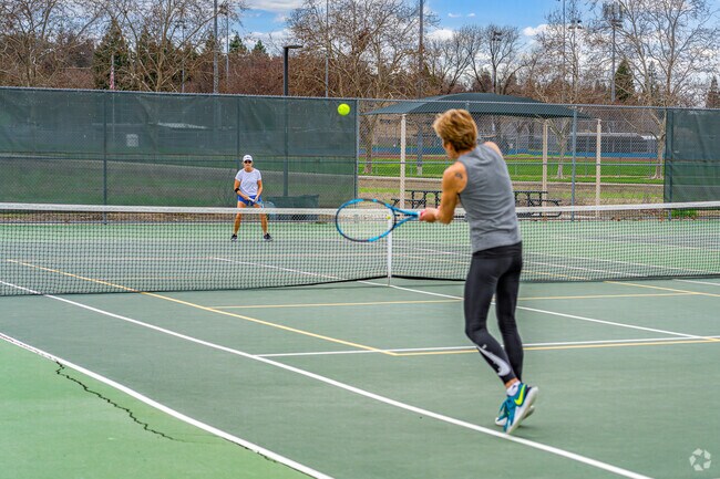 Competitive friends play close game of tennis at Twin Oaks Park in Stanford Ranch.