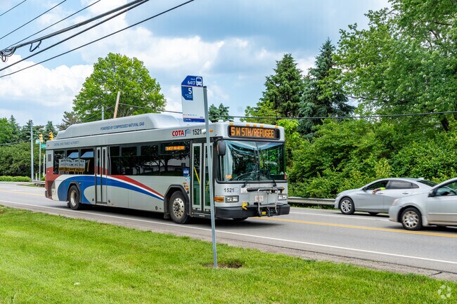 COTA bus line number 5 has a bus stop right in front of the entrance to Trabue Woods.