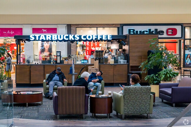 Starbucks has a kiosk in the center of Meadowood Mall that attracts waiting family members.