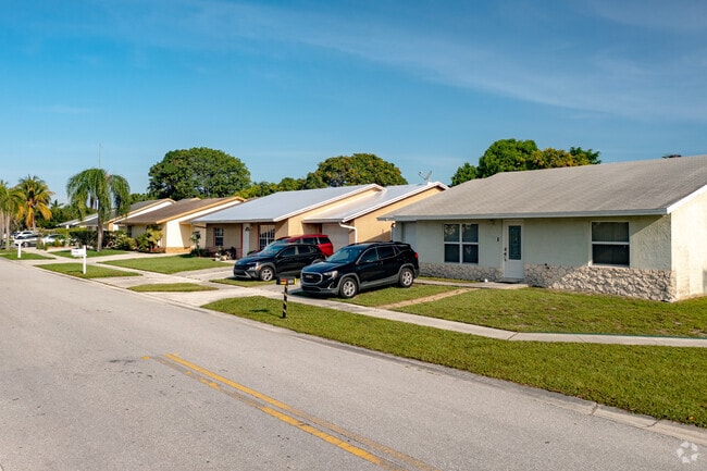 Ranch-style homes line a street in Pine Air, Palm Springs, Florida.