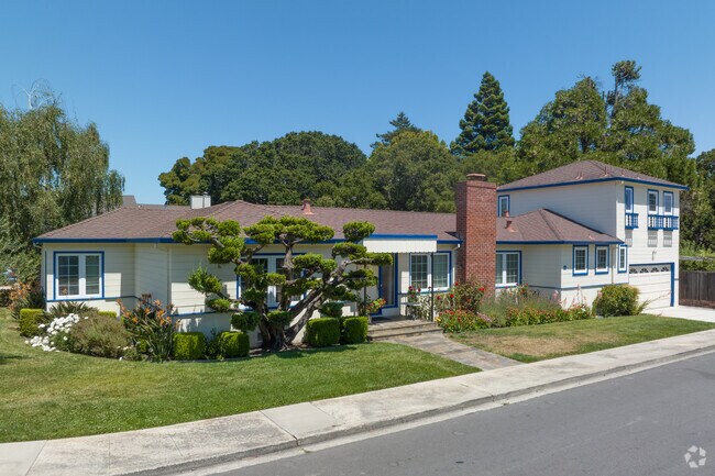 Nicely done front yards and green grass surround this home in Ray Park.