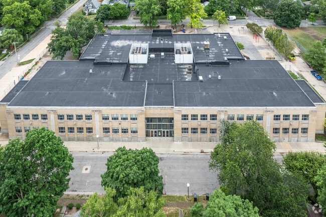 Leal Elementary School sits along a tree-lined street.